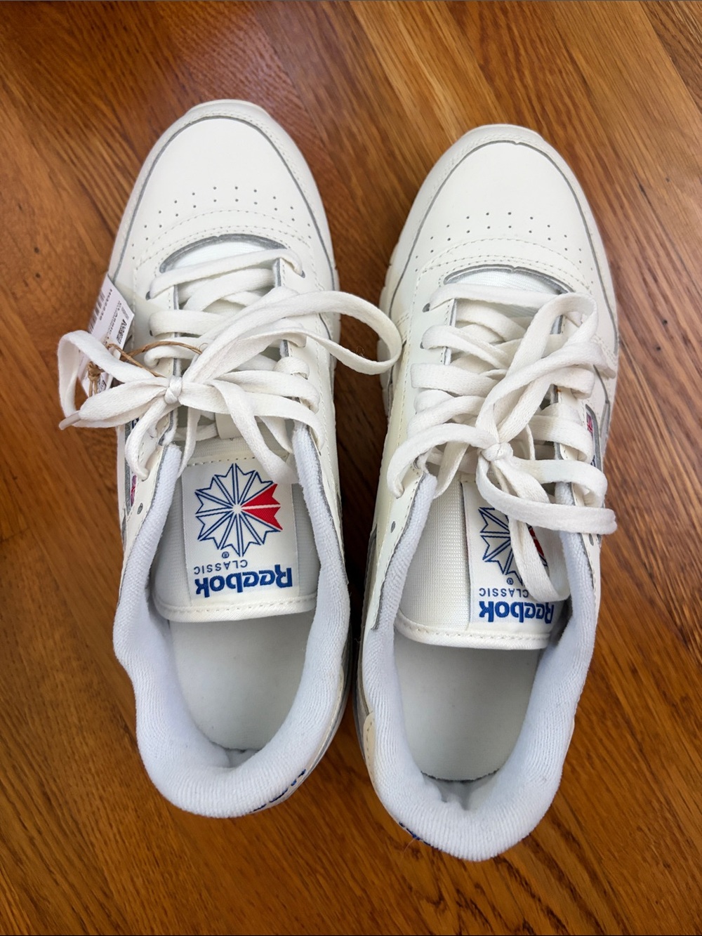 Reebok Women’s White Leather Sneakers with Navy & Red Logo Accents